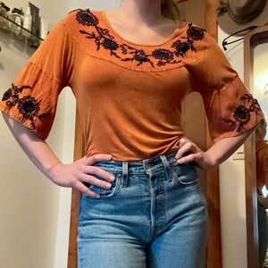 Orange tunic with navy floral embroidery and bell sleeve